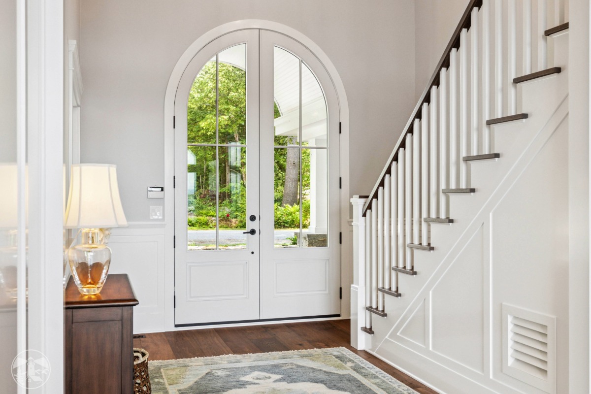 Curved double French doors with eyebrow arch at Lakeside Legacy lake house windows remodel in Gilford NH