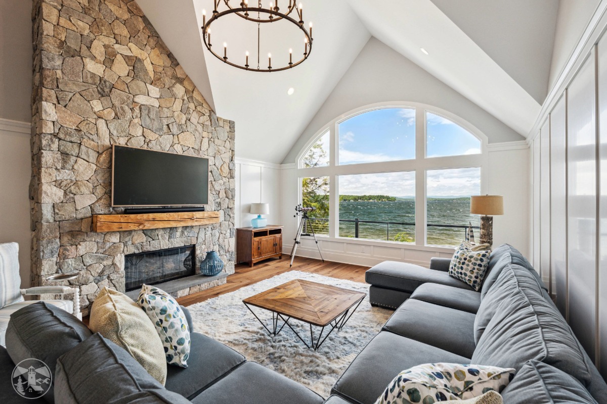 Expansive lake house windows overlooking Lake Winnipesaukee from the Lakeside Legacy Project living room