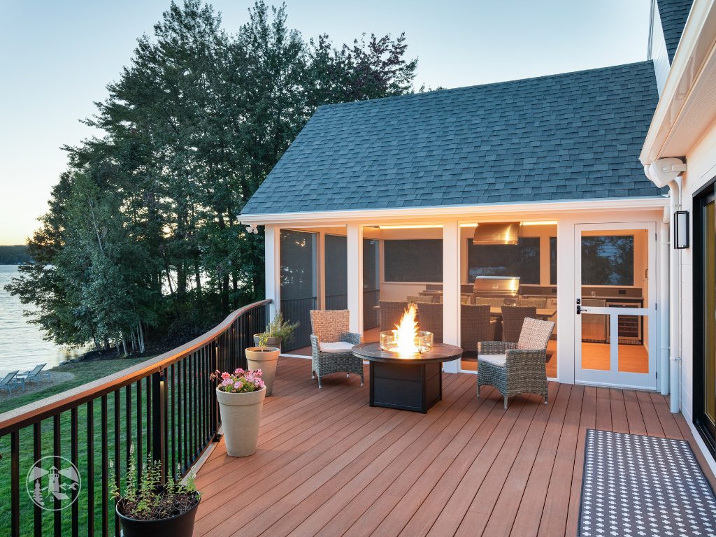 Lakes Region New Hampshire lake house deck remodel with a screened porch, outdoor fire pit, and lake views.
